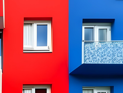 Two apartments in striking colors: on the left, a bright red facade with a white window; on the right, a blue facade with a glass balcony featuring a floral pattern.