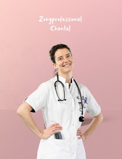 Zorgprofessional in witte labjas met stethoscoop om de nek, staand met handen op de heupen tegen een roze achtergrond.