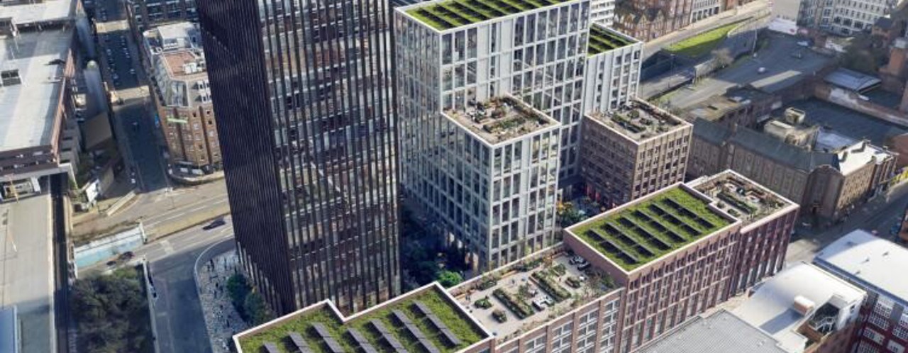 Modern city buildings with green roofs and terraces, situated in an urban environment.