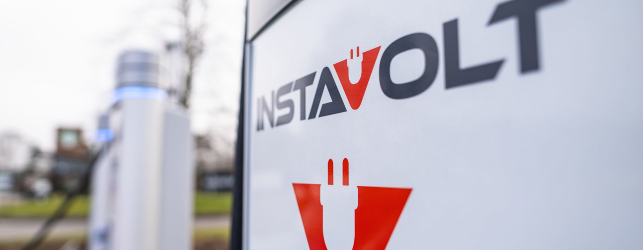Charging station for electric vehicles featuring the InstaVolt logo and an illustration of a plug.