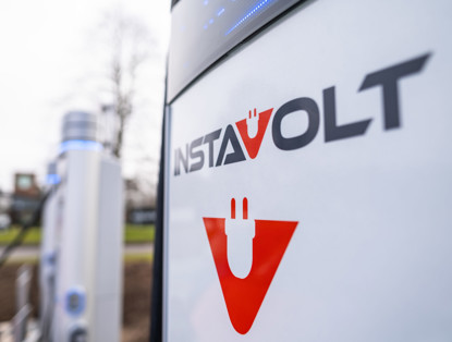 Charging station for electric vehicles featuring the InstaVolt logo and an illustration of a plug.